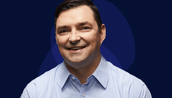 Peter's story Image of retired police officer smiling to the camera wearing light blue business shirt, no tie. Late forties, Anglo male with dark hair.