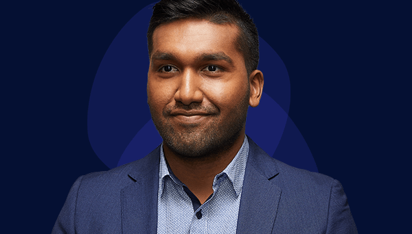 Sean's story Image of current VPS employee looking slightly off camera to the left wearing a light blue shirt with a dark blue suit jacket. Dark skin, slight beard stubble, and black hair